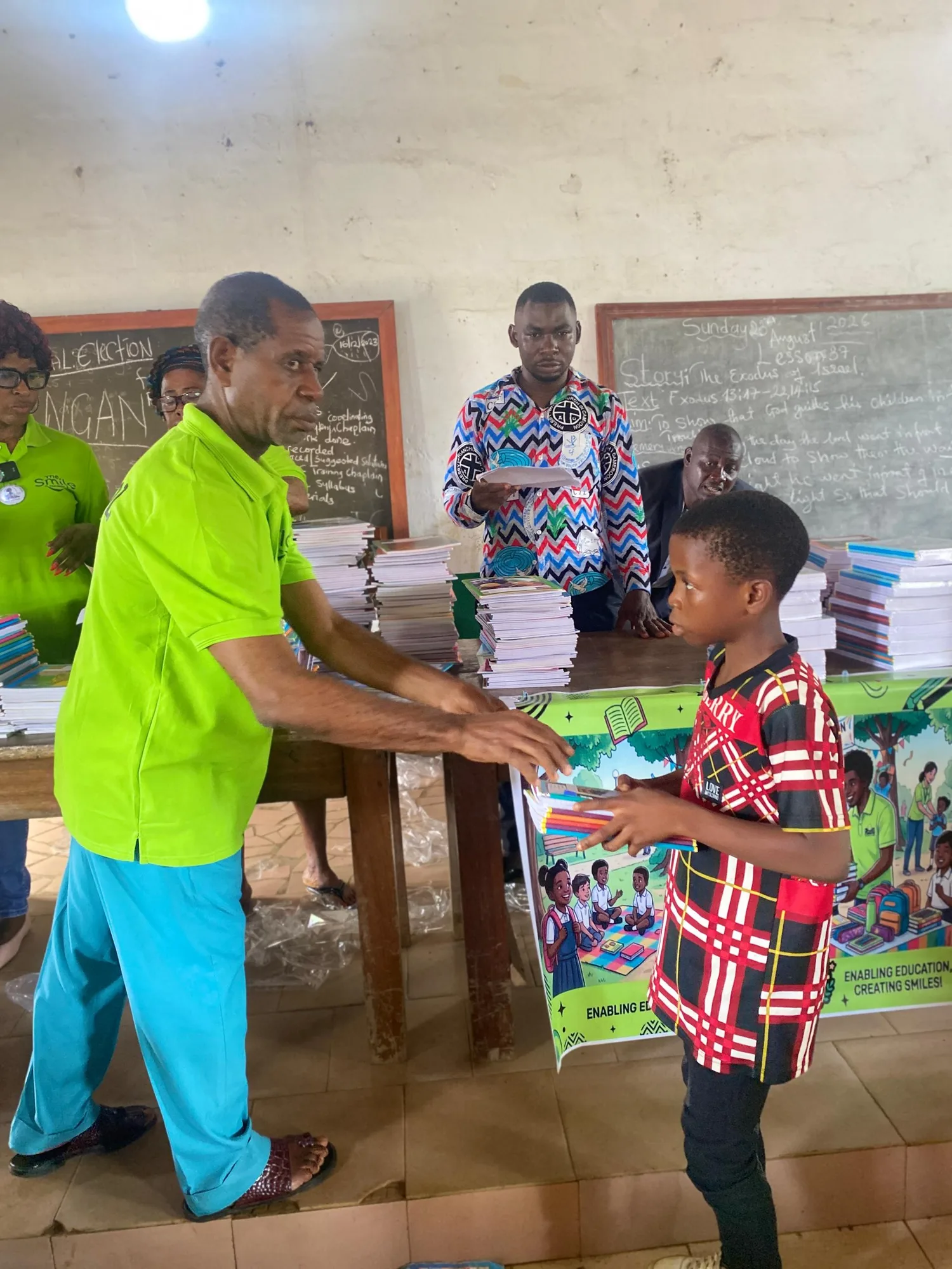 Handing of school materials to Children during the ceremony to present back-to-school support to vulnerable children in Kumba