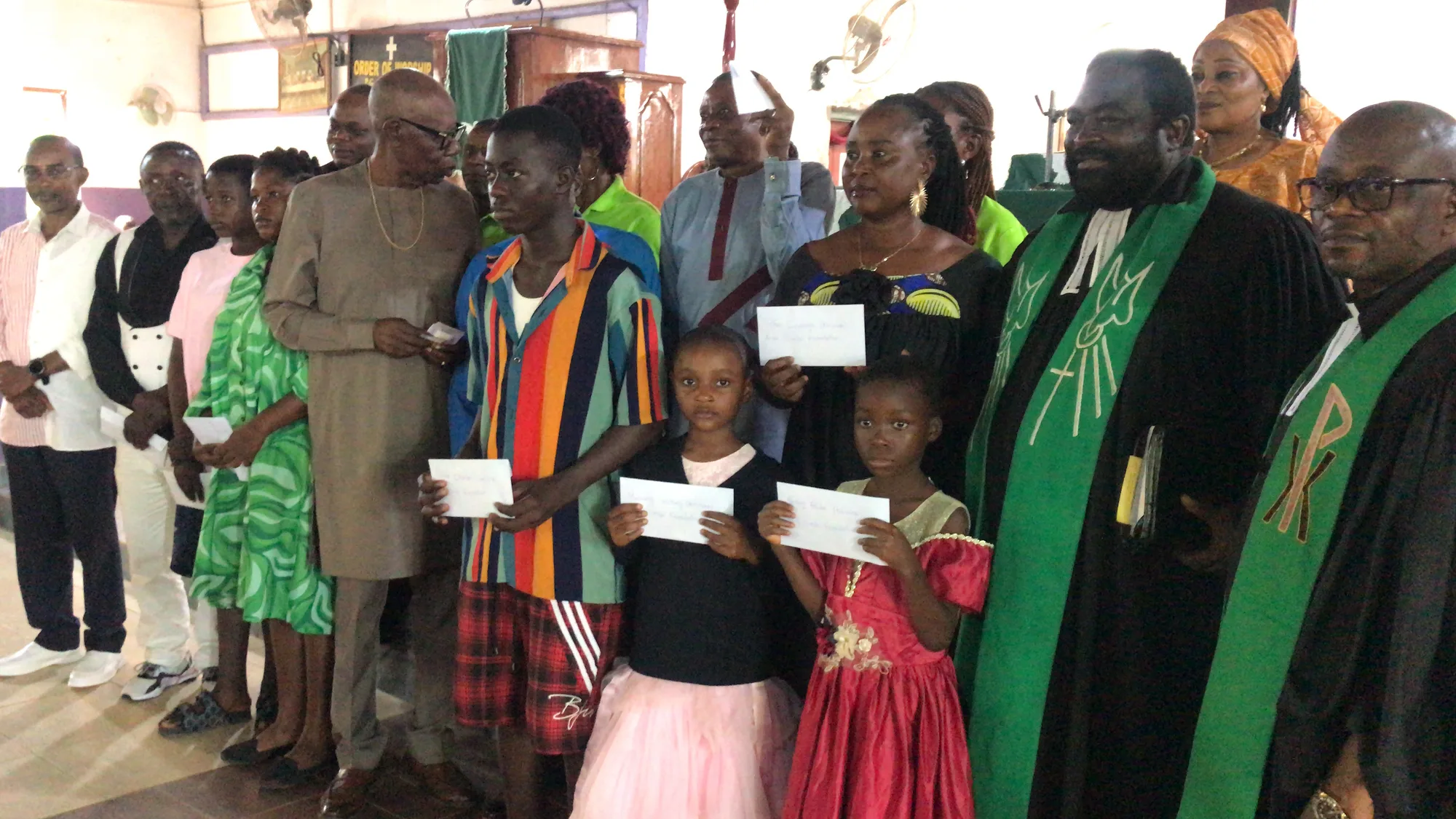 Prince Ndoki Mukete in a group picture with scholarship recepients and members of the Smile Foundation, immediately after he handed the finacial package as support to the Back-to-school campaign